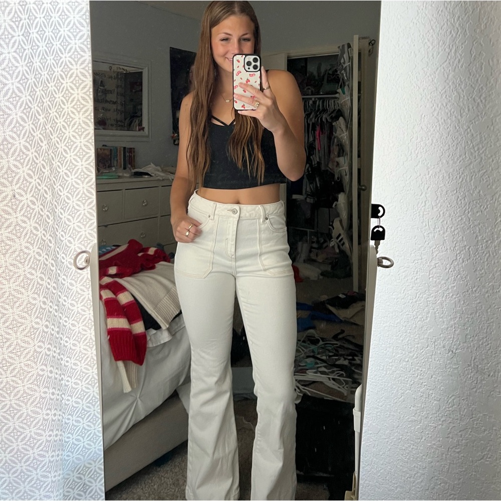White boot, cut jeans.